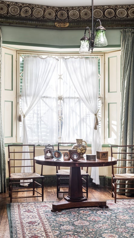 The Drawing Room sash window with table and chairs at A la Ronde, Devon.